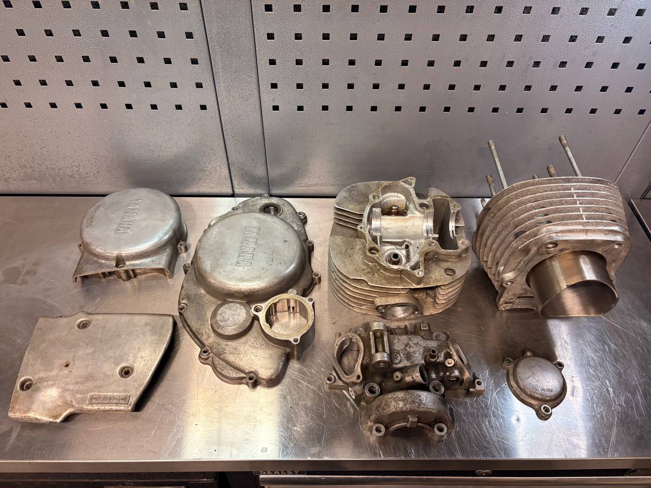 Yamaha motorcycle engine castings with grime, staining and oxidation before VMC vapour blasting