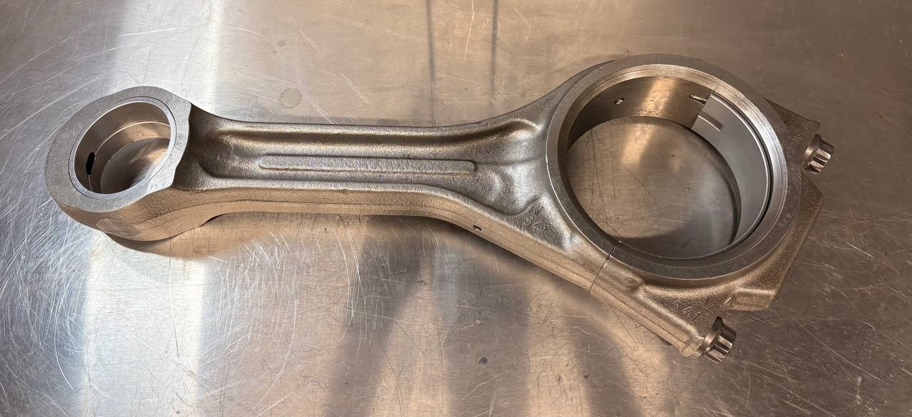 Large steel connecting rod with a clean grey metallic appearance after VMC vapour blasting and ACF-50 application