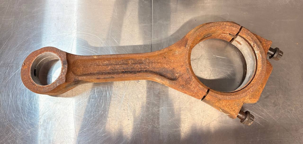 Large 30cm steel connecting rod covered in orange-brown surface rust before VMC vapour blasting